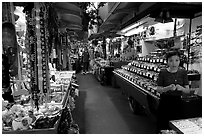 Woman and stands, International Marketplace. Waikiki, Honolulu, Oahu island, Hawaii, USA ( black and white)