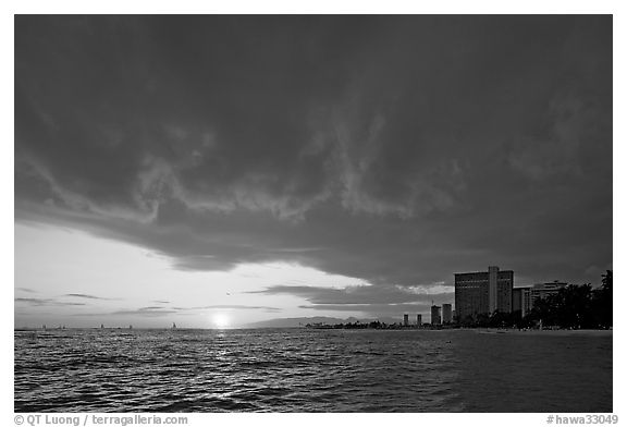 Sun setting and Honolulu skyline. Waikiki, Honolulu, Oahu island, Hawaii, USA (black and white)