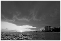 Sun setting and Honolulu skyline. Waikiki, Honolulu, Oahu island, Hawaii, USA (black and white)