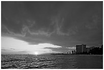 Sun setting and Honolulu skyline. Waikiki, Honolulu, Oahu island, Hawaii, USA ( black and white)