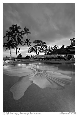 Swimming pool at sunset, Halekulani hotel. Waikiki, Honolulu, Oahu island, Hawaii, USA (black and white)