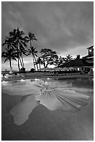 Swimming pool at sunset, Halekulani hotel. Waikiki, Honolulu, Oahu island, Hawaii, USA (black and white)