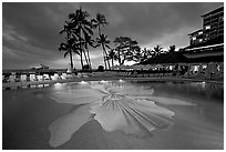 Swimming pool at sunset, Halekulani hotel. Waikiki, Honolulu, Oahu island, Hawaii, USA ( black and white)