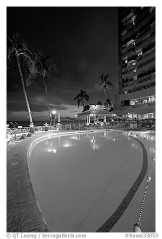 Swimming pool at night, with dance performance, Sheraton hotel. Waikiki, Honolulu, Oahu island, Hawaii, USA