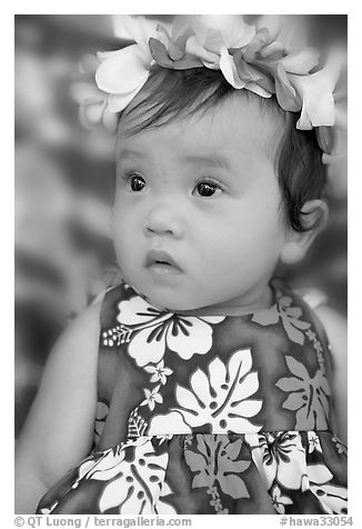 Baby girl in hawaiian dress wearing a flower lei on her head. Waikiki, Honolulu, Oahu island, Hawaii, USA (black and white)