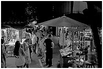 Shoppers amongst craft stands, International Marketplace. Waikiki, Honolulu, Oahu island, Hawaii, USA (black and white)