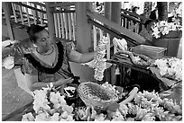 Woman showing  a fresh flower lei, International Marketplace. Waikiki, Honolulu, Oahu island, Hawaii, USA (black and white)