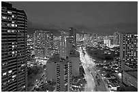 Boulevard and high-rise towers at dusk. Waikiki, Honolulu, Oahu island, Hawaii, USA (black and white)