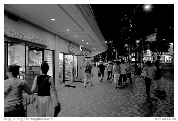Shops on Kalakaua avenue at night. Waikiki, Honolulu, Oahu island, Hawaii, USA (black and white)
