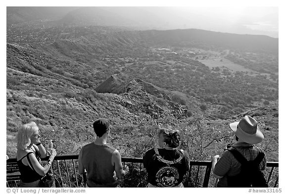 Tourists look at the  Diamond Head crater, early morning. Oahu island, Hawaii, USA