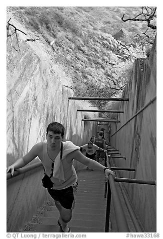 Tourist climbing a staircase on the Diamond Head summit trail. Oahu island, Hawaii, USA