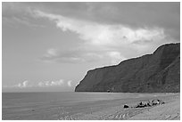 Campers and tire tracks in the sand, Polihale Beach, sunset. Kauai island, Hawaii, USA ( black and white)