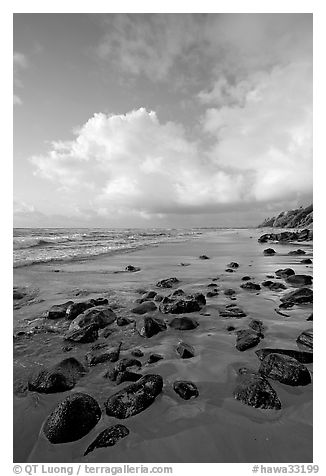 Boulders, coastline, and clouds, Lydgate Park, sunrise. Kauai island, Hawaii, USA