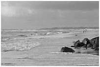 Couple strolling on the beach, Lydgate Park, early morning. Kauai island, Hawaii, USA ( black and white)