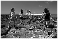 Girls playing in tidepool, Kukuila. Kauai island, Hawaii, USA (black and white)