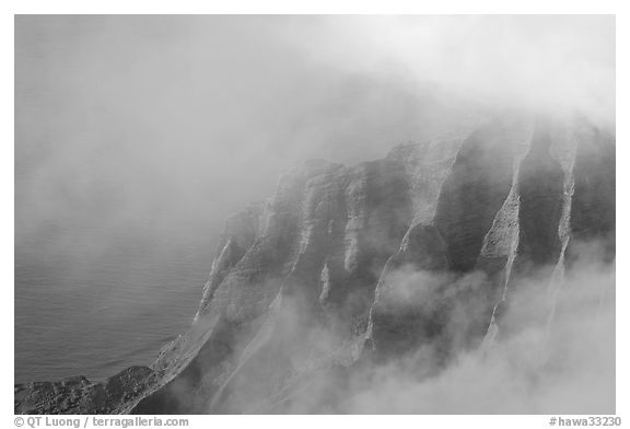 Fluted ridges seen through clouds, Kalalau lookout, late afternoon. Kauai island, Hawaii, USA (black and white)