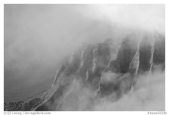 Fluted ridges seen through clouds, Kalalau lookout, late afternoon. Kauai island, Hawaii, USA (black and white)