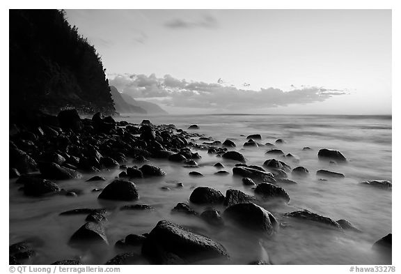 Boulders, surf, and Na Pali Coast, Kee Beach, dusk. Kauai island, Hawaii, USA (black and white)