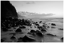 Boulders, surf, and Na Pali Coast, Kee Beach, dusk. Kauai island, Hawaii, USA (black and white)