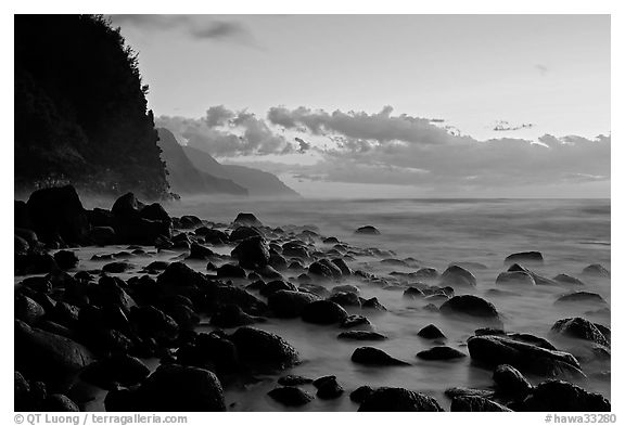 Boulders, surf, and Na Pali Coast, Kee Beach, dusk. Kauai island, Hawaii, USA (black and white)