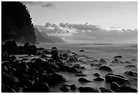 Boulders, surf, and Na Pali Coast, Kee Beach, dusk. Kauai island, Hawaii, USA (black and white)