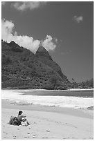 Woman sitting on a beach chair on Tunnels Beach. North shore, Kauai island, Hawaii, USA (black and white)