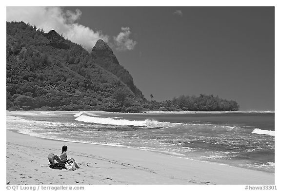 Woman sitting on a beach chair on Makua (Tunnels) Beach. North shore, Kauai island, Hawaii, USA