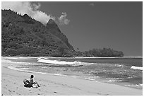 Woman sitting on a beach chair on Makua (Tunnels) Beach. North shore, Kauai island, Hawaii, USA ( black and white)
