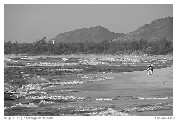 Woman with child on beach, Lydgate Park, early morning. Kauai island, Hawaii, USA