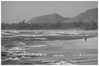 Woman with child on beach, Lydgate Park, early morning. Kauai island, Hawaii, USA ( black and white)