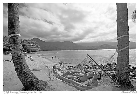 Family on Hammock with Hanalei Bay in the background. Kauai island, Hawaii, USA (black and white)