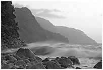 Boulders, waves, and Na Pali Coast, sunset. North shore, Kauai island, Hawaii, USA (black and white)