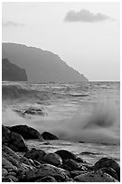 Boulders, waves, and Na Pali cliffs, sunset. Kauai island, Hawaii, USA ( black and white)