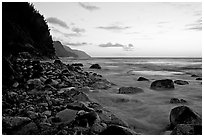 Boulders, waves, and Na Pali Coast, sunset. North shore, Kauai island, Hawaii, USA (black and white)