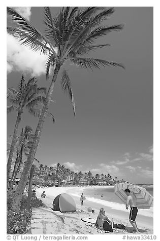 Couple and tent, Sheraton Beach, mid-day. Kauai island, Hawaii, USA (black and white)