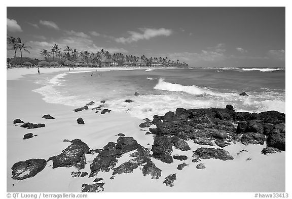 Dark rocks and Kiahuna Beach, mid-day. Kauai island, Hawaii, USA (black and white)