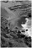 Beachgoers and green sand beach near South Point. Big Island, Hawaii, USA (black and white)