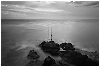 Fishing rods at sunset, Ka Lea (South Point). Big Island, Hawaii, USA (black and white)