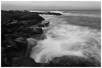 Surf and lava shoreline at sunset, South Point. Big Island, Hawaii, USA ( black and white)