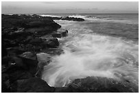 Surf and lava shoreline at sunset, South Point. Big Island, Hawaii, USA (black and white)