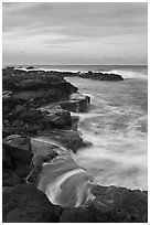 Surf and volcanic shore at sunset, South Point. Big Island, Hawaii, USA (black and white)