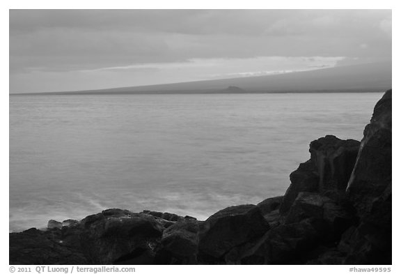 Lava rock shore and Mauna Loa shield profile from South Point. Big Island, Hawaii, USA (black and white)
