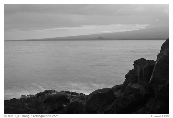 Lava rock shore and Mauna Loa shield profile from South Point. Big Island, Hawaii, USA