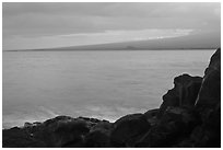 Lava rock shore and Mauna Loa shield profile from South Point. Big Island, Hawaii, USA (black and white)