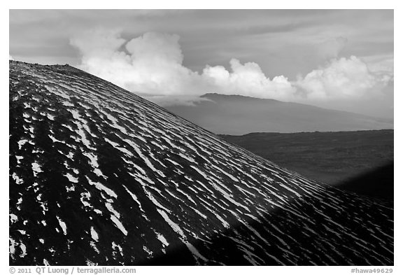 Cinder cone with snow stripes, distant clouds. Mauna Kea, Big Island, Hawaii, USA