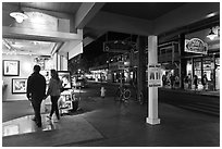 Couple entering art gallery. Lahaina, Maui, Hawaii, USA ( black and white)