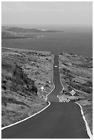 One-lane road overlooking ocean. Maui, Hawaii, USA (black and white)