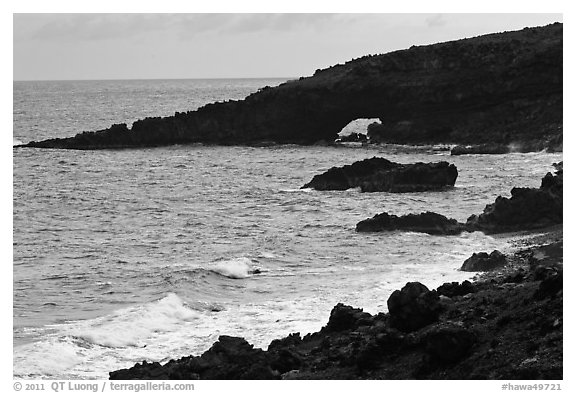 Dark coastline with sea tunnel. Maui, Hawaii, USA (black and white)