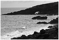 Dark coastline with sea tunnel. Maui, Hawaii, USA (black and white)