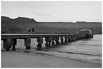 Conversation on Hanalei Pier. Kauai island, Hawaii, USA (black and white)